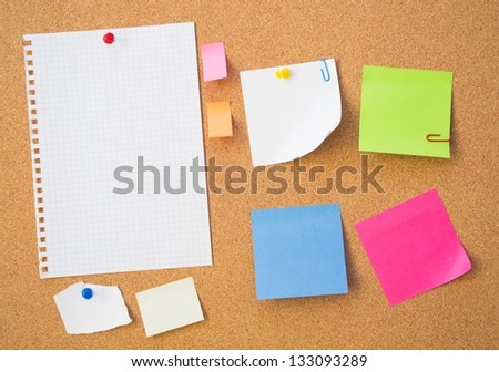 Color note papers on pin board. Cork background