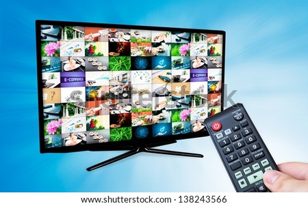 TV with multiple images gallery on blue background. Hand hold remote control