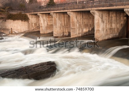 time exposure of slowing water at the flood control gate on the Rideau river at Hog\'s Back Falls in Ottawa