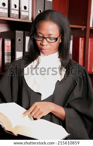 attractive serious, lawyer reading in a legal book