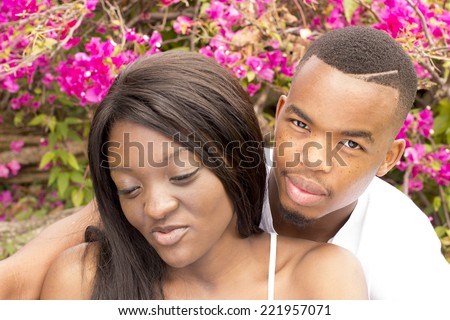 Loving Black couple in the park hugging each other