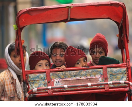 NEW DELHI, INDIA Ã¢Â?Â? FEBRUARY 24: School children wait to be taken to school in street cycle rickshaw outside Jama Masjid Mosque on February 24, 2013 in New Delhi, National Capital Region, North India