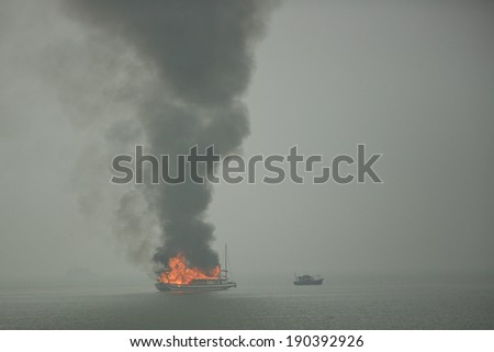 Halong Bay, Vietnam - April 10, 2014: Burning junk boat used predominantly as tourist sight-seeing boats in Halong Bay. Halong Bay is a UNESCO World Heritage Site.