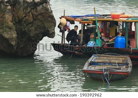 Halong Bay, Vietnam - April 10, 2014: Fishing boat in Halong Bay used predominantly to supply the local floating villages. Halong Bay is a UNESCO World Heritage Site.
