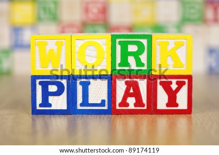 Work Play Spelled Out in Alphabet Building Blocks