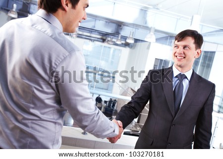 Image of two business men handshaking and concluding the deal