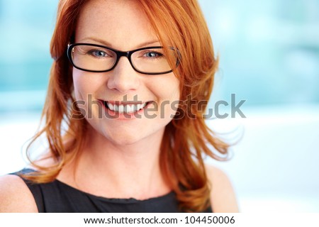 Close-up shot of a wonderful red-haired woman with a pleasant smile