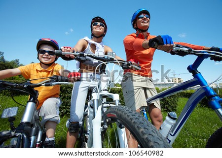 Sportive family keeping fit cycling on a clear summer day