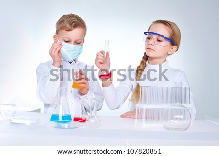 Young scientists mixing chemical substances in the lad