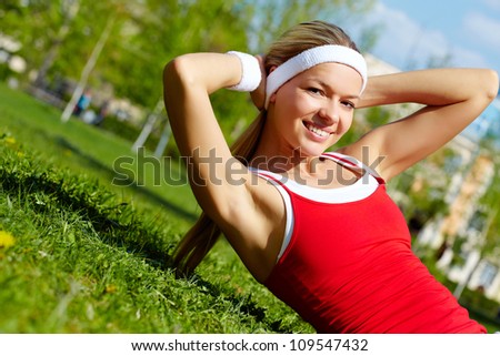 Portrait of a young woman doing physical exercise outdoors