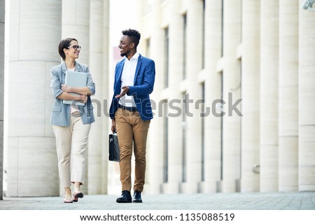 Similar – Image, Stock Photo Stylish black businessman chatting on smartphone against building wall