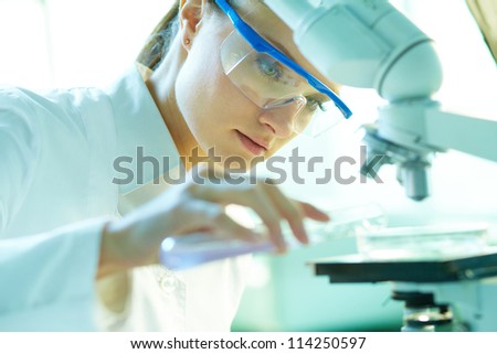 Serious female chemist working in laboratory
