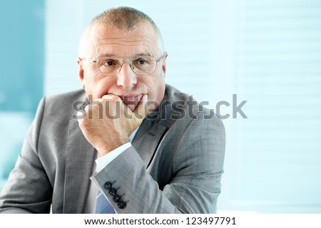 Portrait of elderly businessman concentrating on something