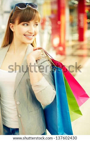 Vertical shot of a joyful consumer spending time shopping