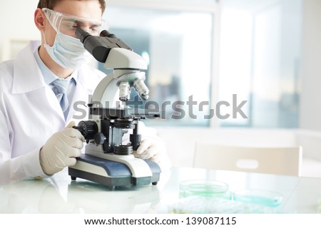 Similar – Image, Stock Photo Serious clinician studying chemical element in laboratory
