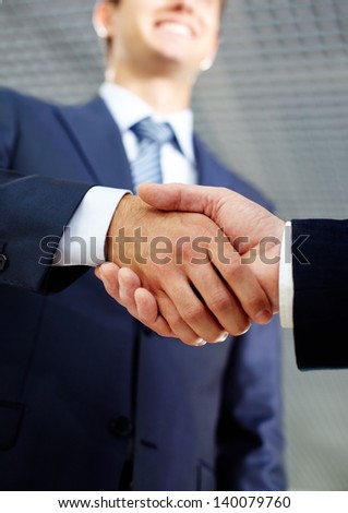 Close-up of two businessmen handshaking after making agreement