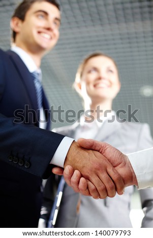 Close-up of two men hands shaking after signing contract