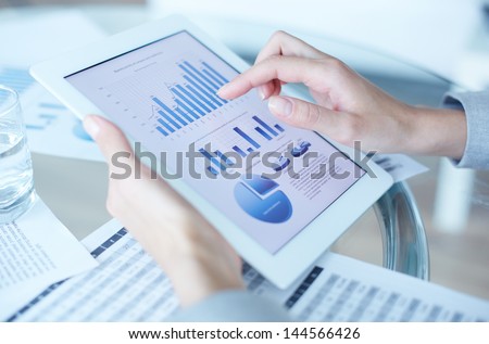 Hands of businesswoman holding touchpad with electronic document