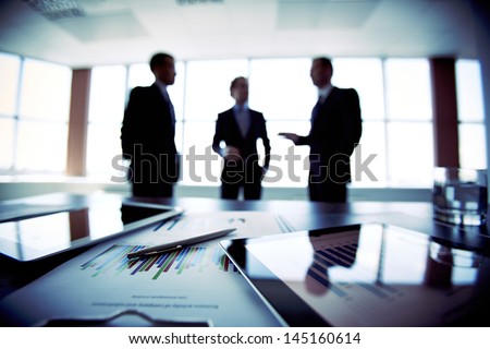 Colleagues meeting to discuss their future financial plans, only silhouettes being viewed
