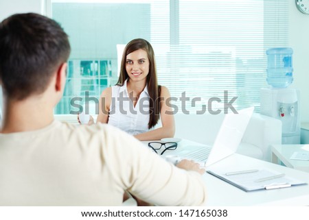 Photo of cute secretary looking at her boss in office