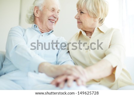 Happy elderly man looking at his wife