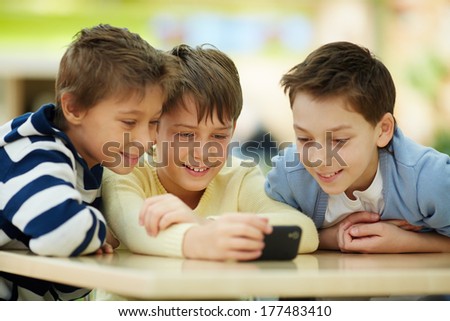 Three boys surfing the net on smartphone