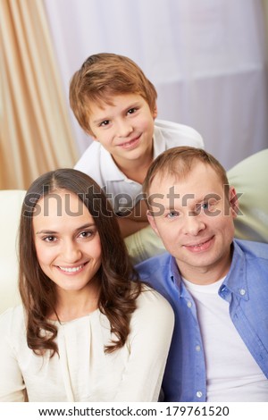 Portrait of happy family with son looking at camera