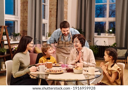 Similar – Foto Bild Zwei brennende Kerzen zwischen mehreren Reihen von roten Kerzen in einer Kirche