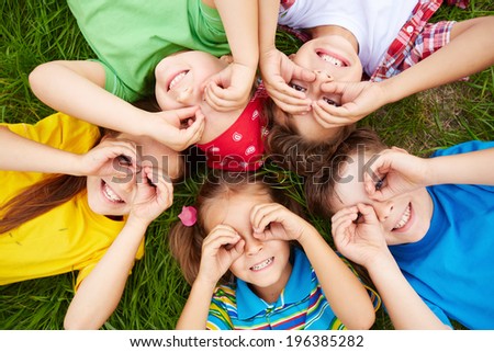 Similar – Image, Stock Photo Cute child lying on carpet at home and playing on console