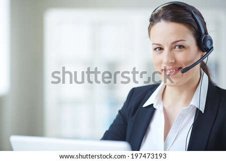 Young customer support representative looking at camera with smile
