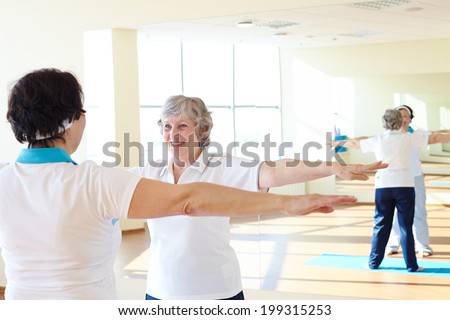 Portrait of sporty females doing physical exercise in sport gym