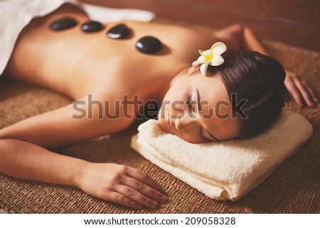 Portrait of young female lying in spa salon during beauty procedure