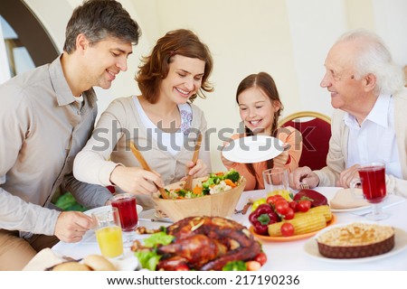 Portrait of affectionate family by Thanksgiving table
