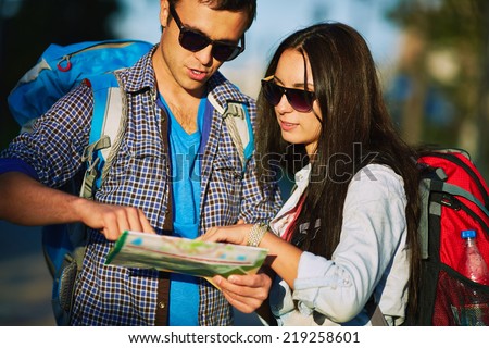 Young travelers with guide deciding where to go