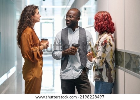 Similar – Image, Stock Photo Elegant black man talking smartphone leaning building