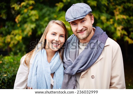 Stylish young man and woman looking at camera