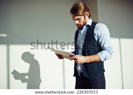 Serious businessman working with papers