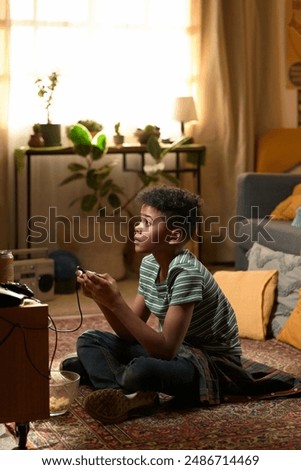 Similar – Image, Stock Photo Concentrated boy playing video game