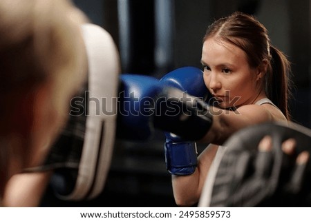 Similar – Image, Stock Photo Serious sportswoman with boxer braids posing with crossed arms