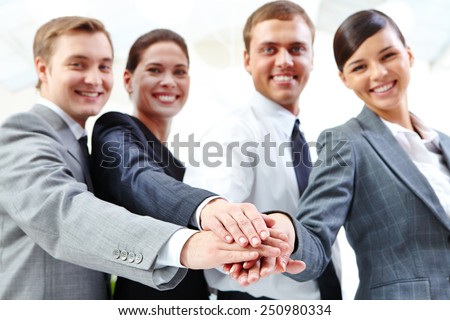 Business partners keeping their hands on top of each other