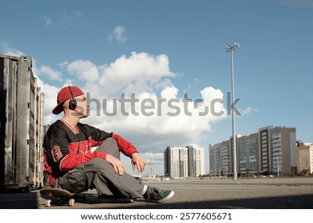 Similar – Foto Bild Entspannter männlicher Skater beim Musikhören in der Stadt