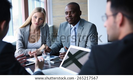 Pretty businesswoman and confident man listening to colleague at meeting