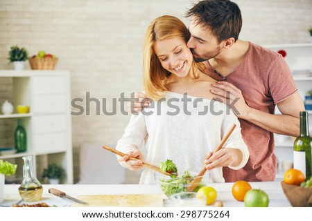 Similar – Image, Stock Photo Couple kissing in kitchen on counter