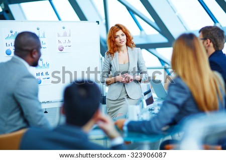 Pretty manager listening to colleagues after explanation of her idea