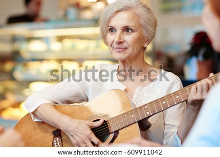 Similar – Image, Stock Photo Calm woman playing guitar in bedroom