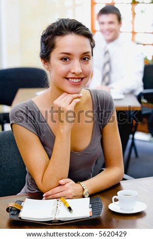 Portrait of a confident business woman with charming smile in the cafe