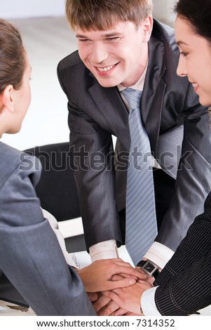 Business team putting their hands on top of each other