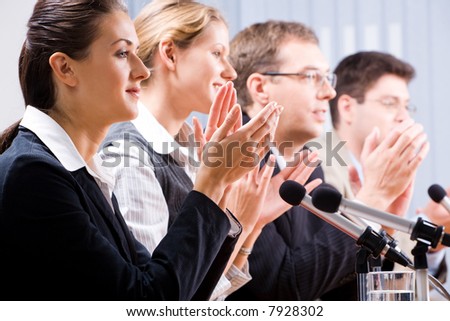 Portrait of several confident people clapping their hands