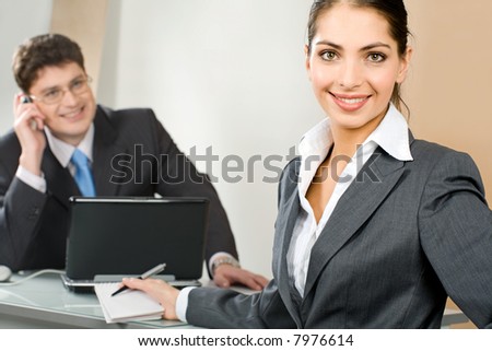 Portrait of young business woman looking at camera in a office