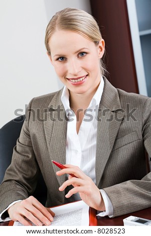 Portrait of bossy woman sitting at a table and looking at camera